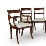 A set of six Regency mahogany sabre leg dining chairs