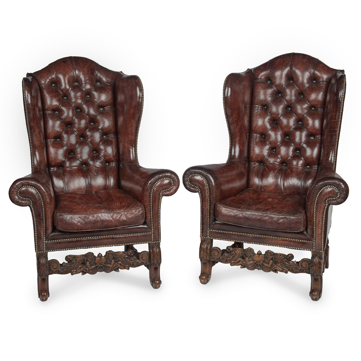 A Fine Pair of 1920s Walnut and Leather Wing Chairs in the Late Baroque Manner and of Baronial Size and Scale